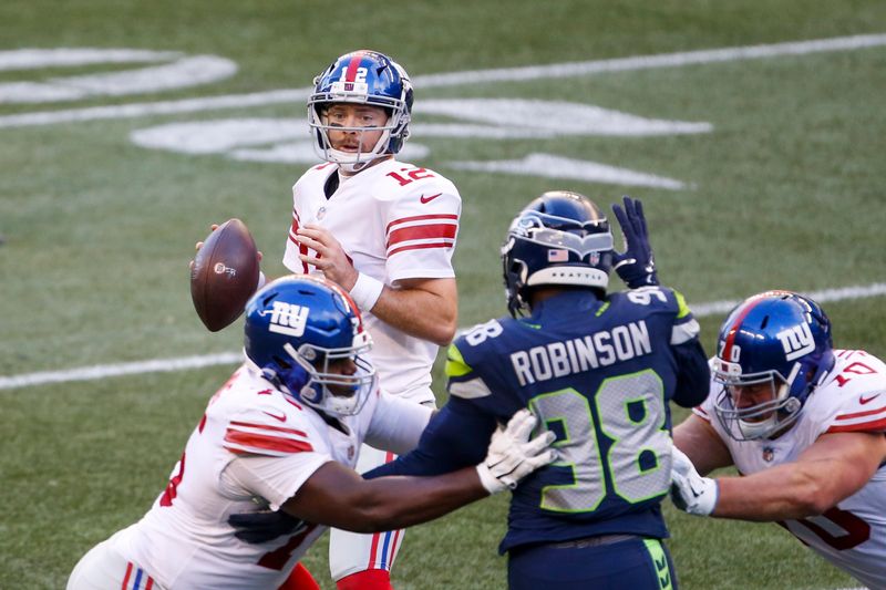 Dec 6, 2020; Seattle, Washington, USA; New York Giants quarterback Colt McCoy (12) looks to pass against the Seattle Seahawks during the third quarter at Lumen Field. Mandatory Credit: Joe Nicholson-USA TODAY Sports