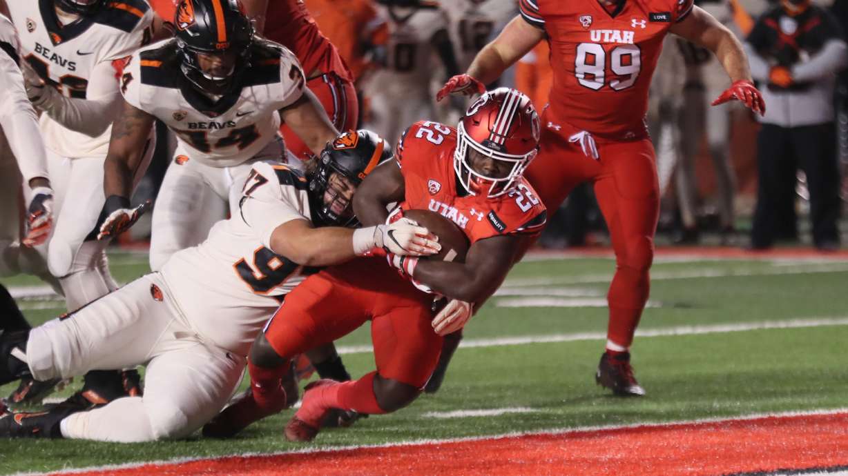 Freshman running back Ty Jordan punches it into the end zone for his first career touchdown against Oregon State at Rice-Eccles Stadium on Dec. 5, 2020.