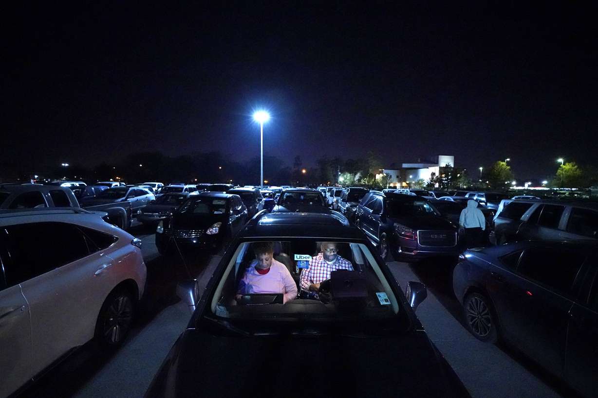 Norman Butler, a first time food bank user, and his girlfriend Cheryl Butler wait overnight in their car, along with others lined up to receive food at a distribution point in Metairie, La., Thursday, Nov. 19, 2020.