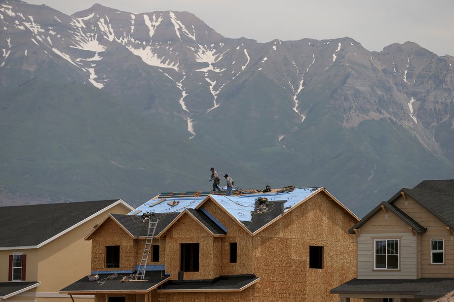 Construction crews work atop the roof of a home being built in Vineyard in 2016. As the Beehive State continues to grapple with issues caused by rapid growth, the majority of residents trust local leaders over the state government to plan for infrastructure needs, according to the Utah League of Cities and Towns.
