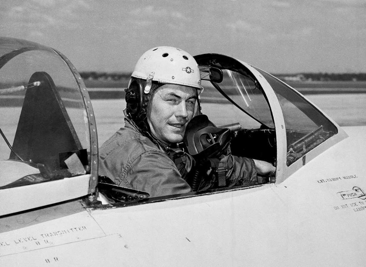 FILE - In this 1948 file photo, test pilot Charles E. Yeager, 25, poses for a picture in a jet's cockpit. Yeager was first to fly faster than the speed of sound. Another Yeager feat, flying a jet under a Charleston, W.Va., bridge in 1948, was not reported by the local media. Yeager died Monday, Dec. 7, 2020, at age 97.