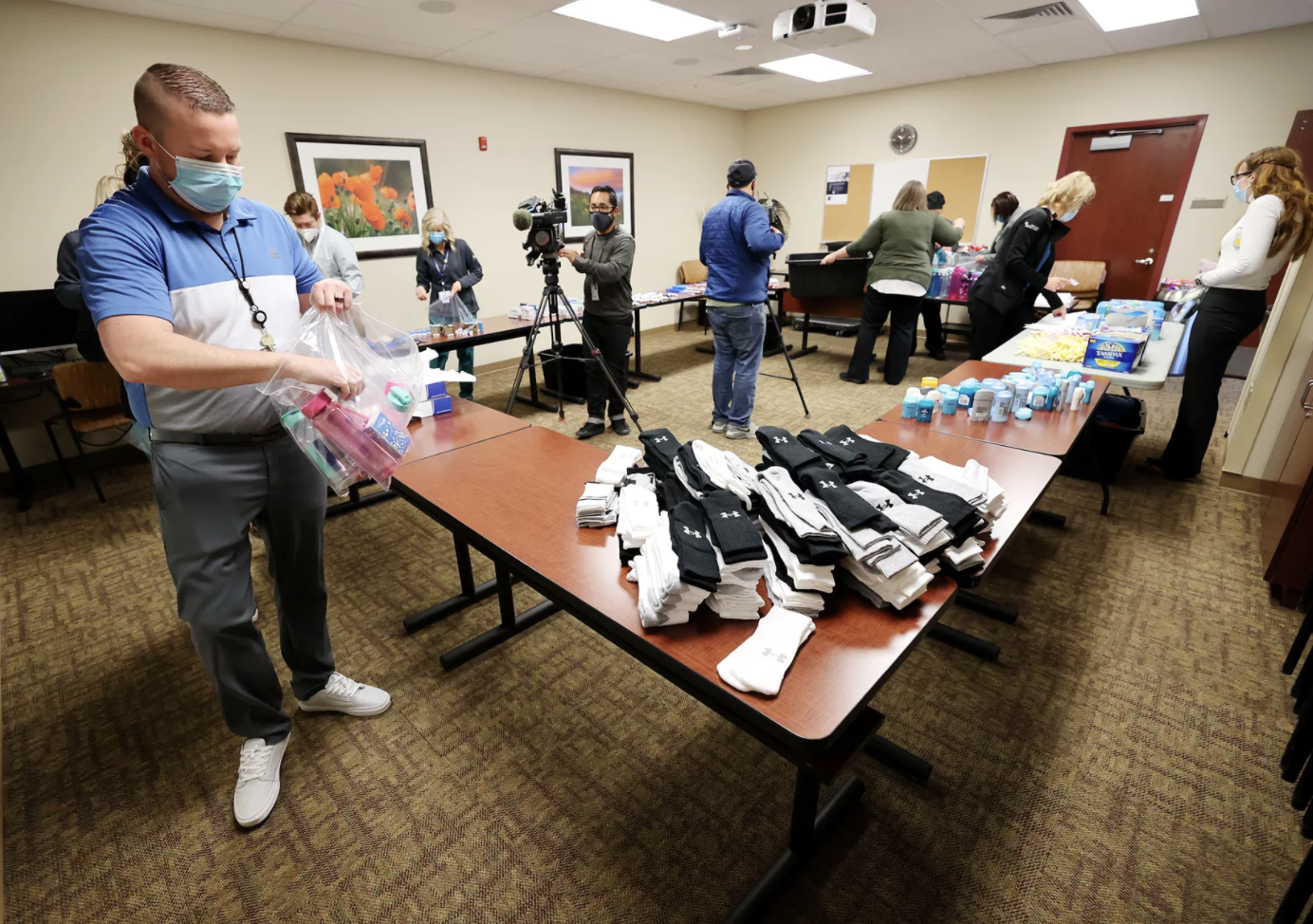 Ryan Howell, director of clinical informatics at Lone Peak Hospital, joins other employees in assembling self-care kits for local homeless shelters on Tuesday, Dec. 8, 2020. The items were gathered by the employees over the past few weeks.