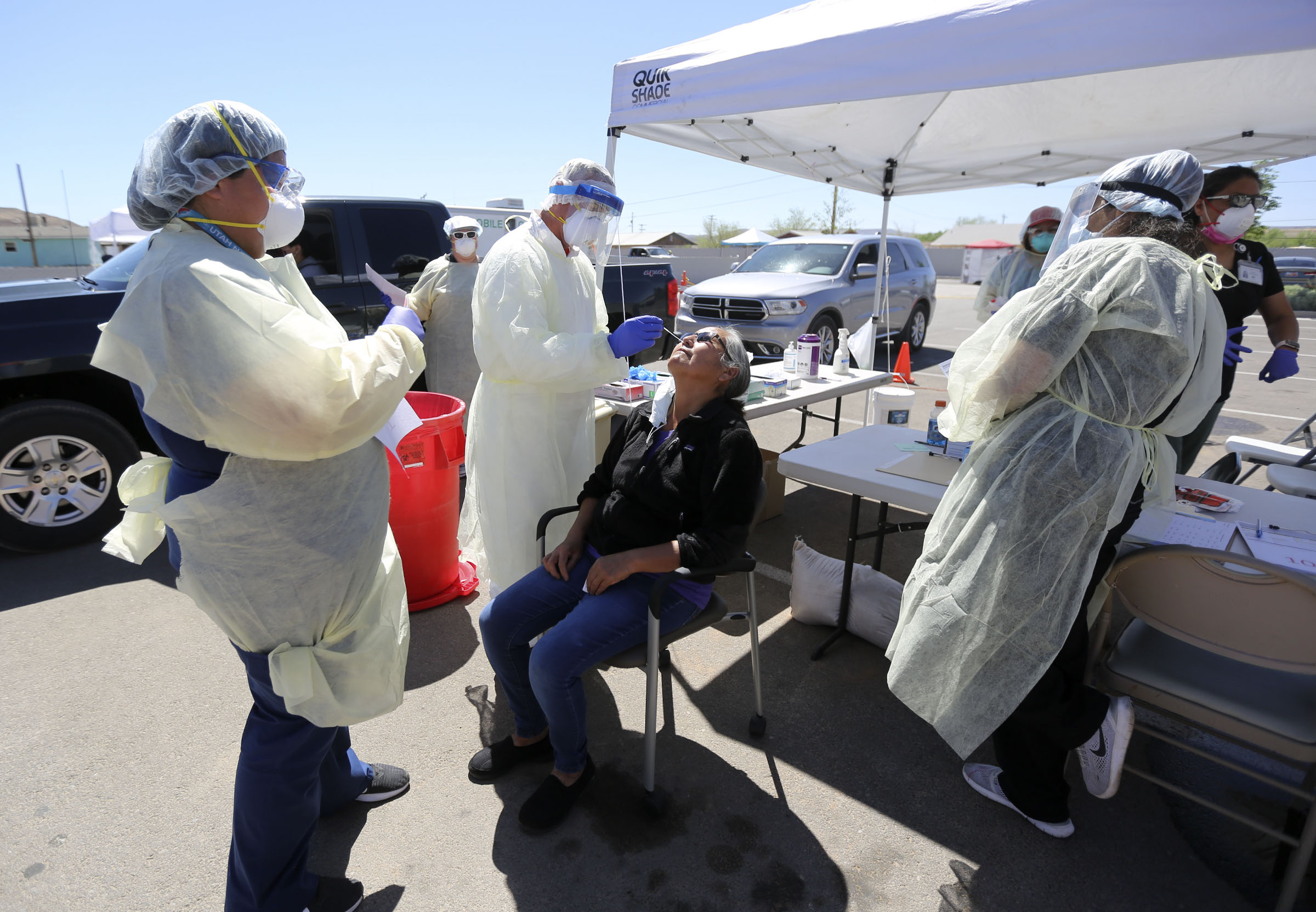 Andy Byrnes, a contracted EMT with the Utah Department of Health, tests Darlene Eddie, Utah Navajo Health System outreach supervisor, for COVID-19 outside of the Montezuma Creek Community Health Center in Montezuma Creek, San Juan County, on Friday, May 1, 2020.