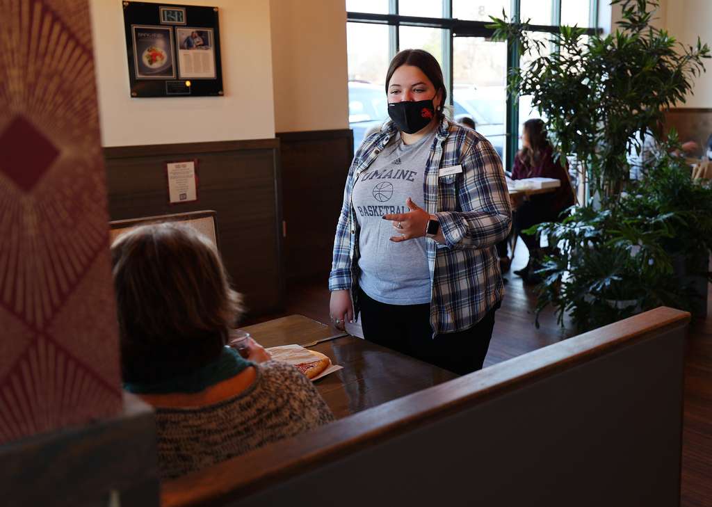 Server Cassie Lambert talks with customers at Oak Wood Fire Kitchen in Draper on Tuesday, Dec. 8, 2020.