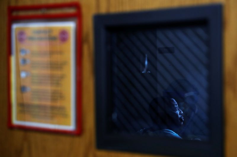 Bruce Shackleford, a coronavirus disease (COVID-19) positive patient, sits in his isolation room at Roseland Community Hospital on the South Side of Chicago, Illinois, U.S., December 8, 2020. REUTERS/Shannon Stapleton