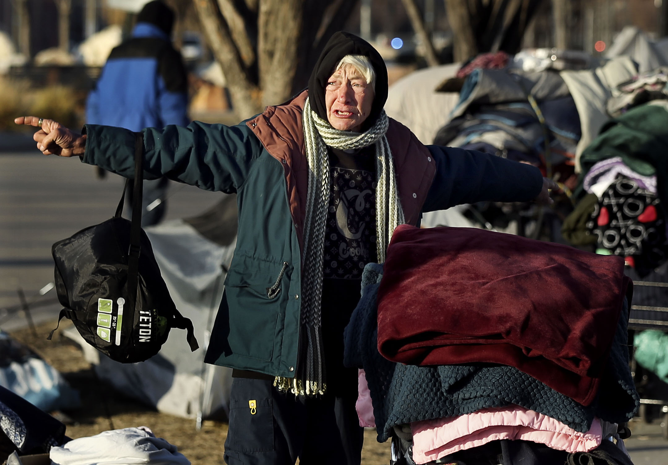 A woman screams as Salt Lake County Health Department workers clean up homeless encampments on 500 West and 400 South in Salt Lake City on Wednesday, Dec. 9, 2020. According to the department, the cleanup is part of the the department's routine operations that occur about once a week.