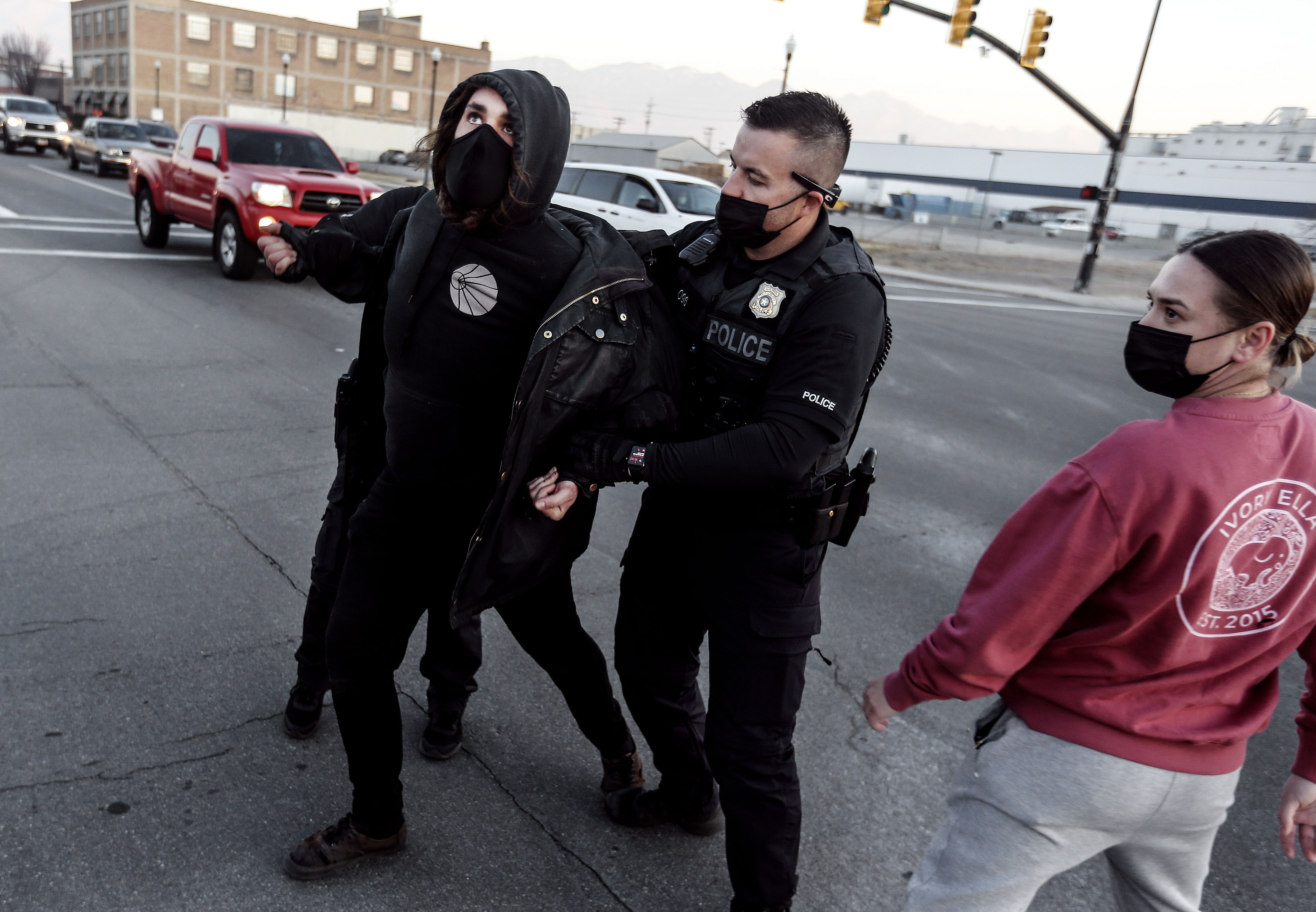 A protester is detained by Salt Lake police officers during a clash over the Salt Lake County Health Department’s efforts to clean up homeless encampments in Salt Lake City on Wednesday, Dec. 9, 2020. According to the department, the cleanup is part of the the department’s “routine operations” that occur about once a week.