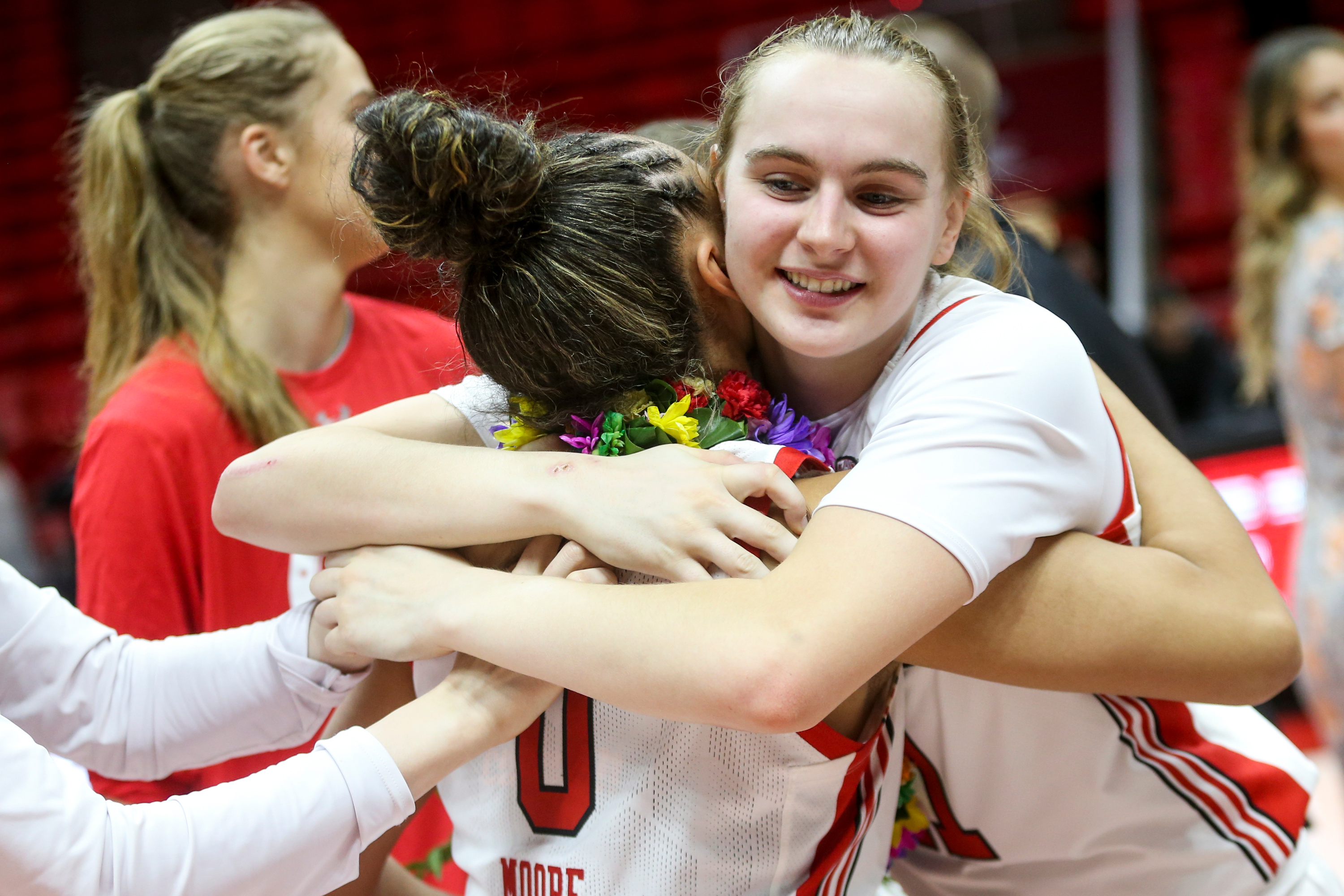 Utah Utes guard Brynna Maxwell (11) hugs senior guard Kiana Moore (0)  on senior day after the Utes beat the Arizona State Sun Devils at the Jon M. Huntsman Center in Salt Lake City on Sunday, Feb. 23, 2020.