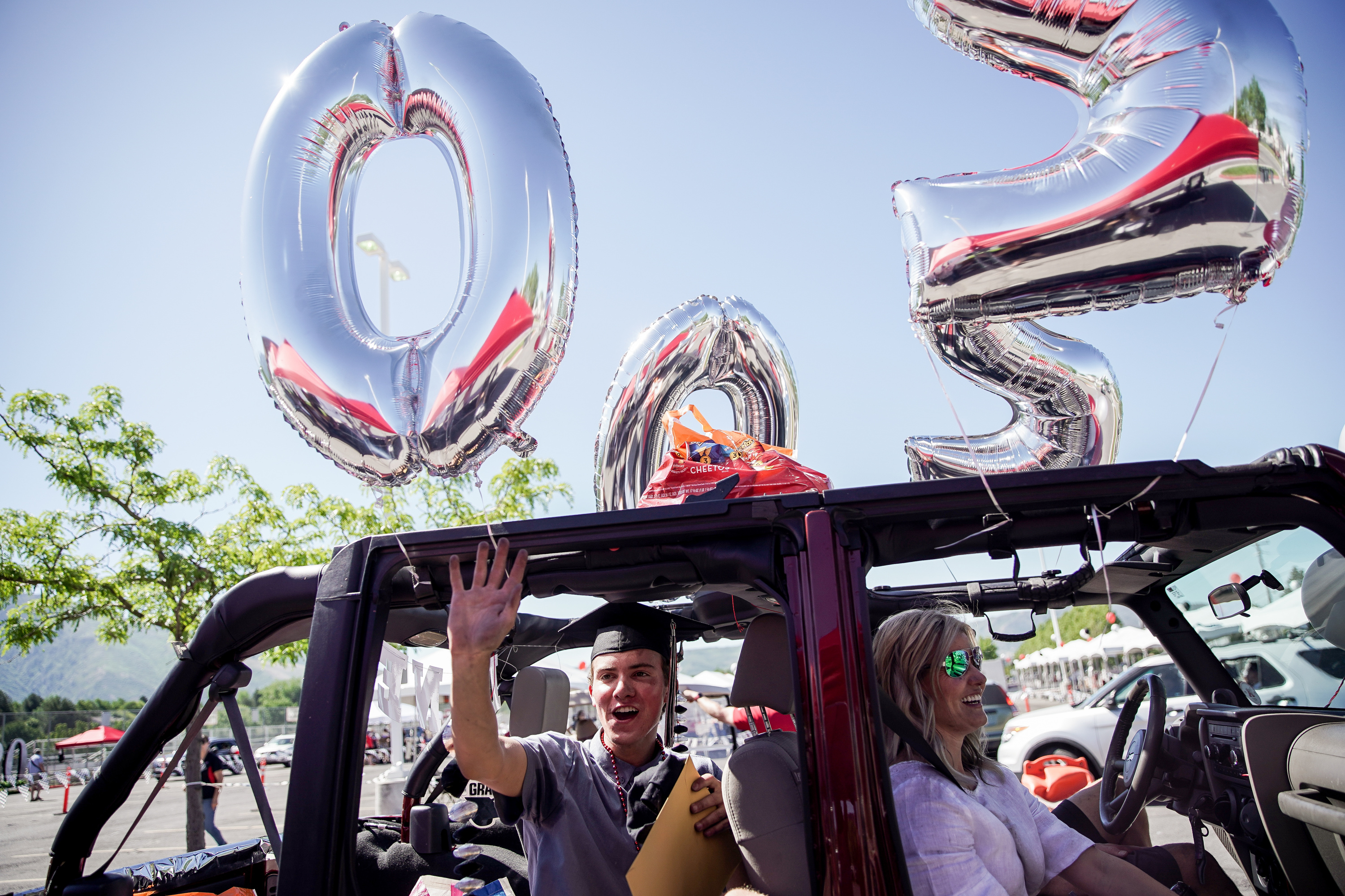 Vito Vincent waves after receiving his diploma at a drive-thru graduation ceremony at Alta High School in Sandy on Thursday, May 28, 2020.