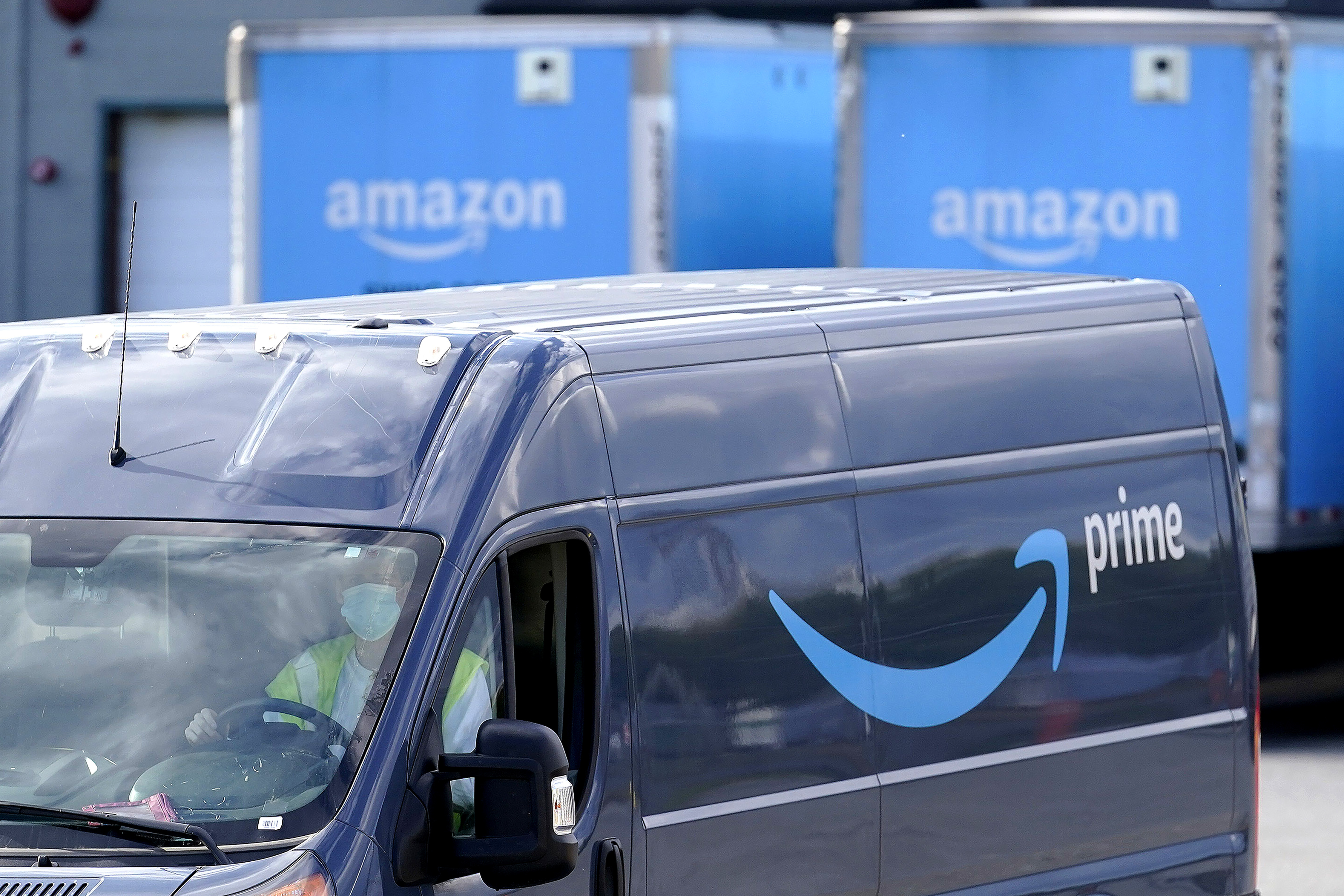FILE - In this Oct. 1, 2020 file photo,  an Amazon Prime logo appears on the side of a delivery van as it departs an Amazon Warehouse location in Dedham, Mass. A number of stores are encouraging shoppers on their websites to order online in the next few days - unless they want to pay for expedited shipping fees to ensure their items are delivered in time for Christmas. Amazon hasn’t released a holiday shipping deadline yet, but said in a statement that it will be delivering packages up until Christmas Eve.  (AP Photo/Steven Senne, File) [Dec-11-2020]