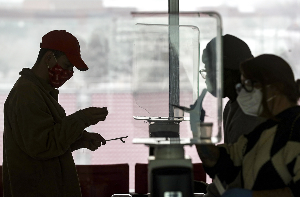 University of Utah student Justin Ellis prepares to swab his nostril for a rapid COVID-19 test at Rice-Eccles Stadium in Salt Lake City on Wednesday, Nov. 11, 2020. The university has launched an initiative to test 32,000 students for COVID-19 before the Thanksgiving break.