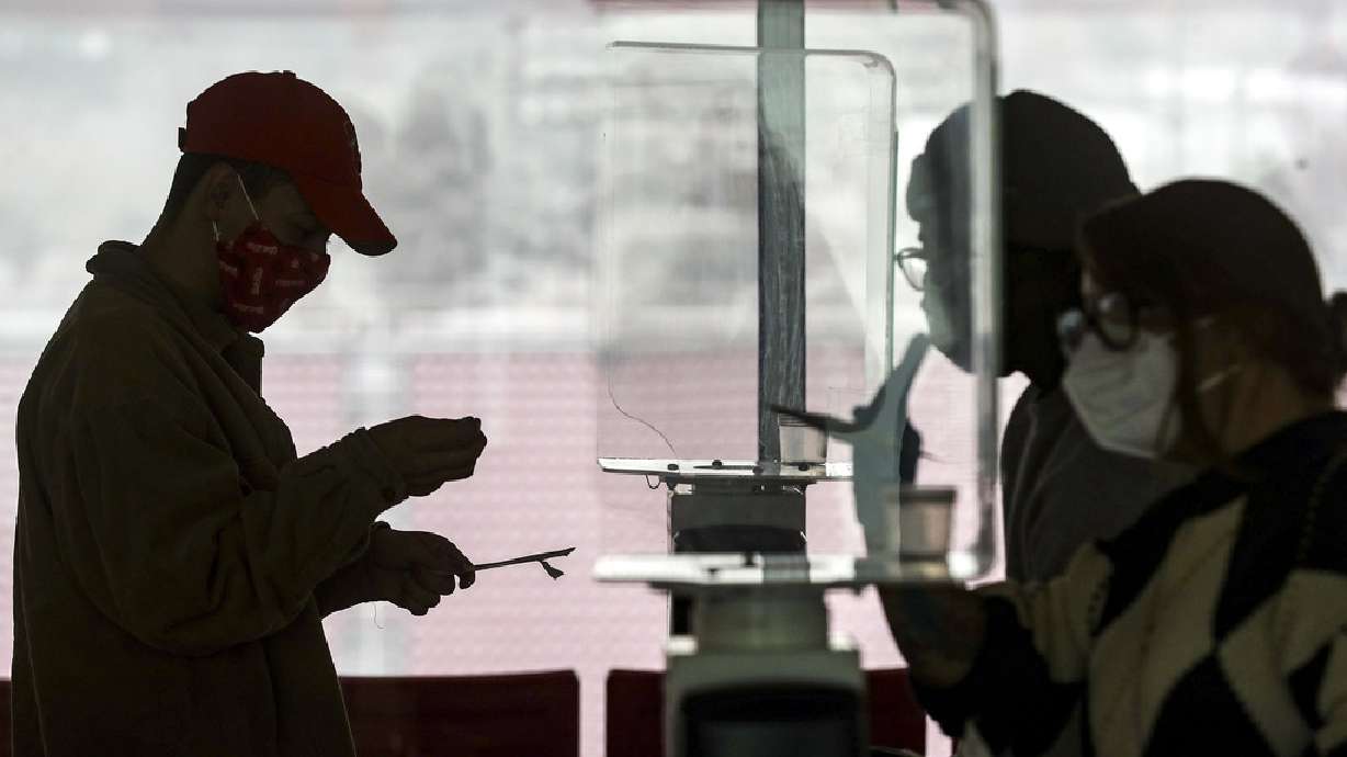 University of Utah student Justin Ellis prepares to swab his nostril for a rapid COVID-19 test at Rice-Eccles Stadium in Salt Lake City on Wednesday, Nov. 11, 2020. The university has launched an initiative to test 32,000 students for COVID-19 before the Thanksgiving break.