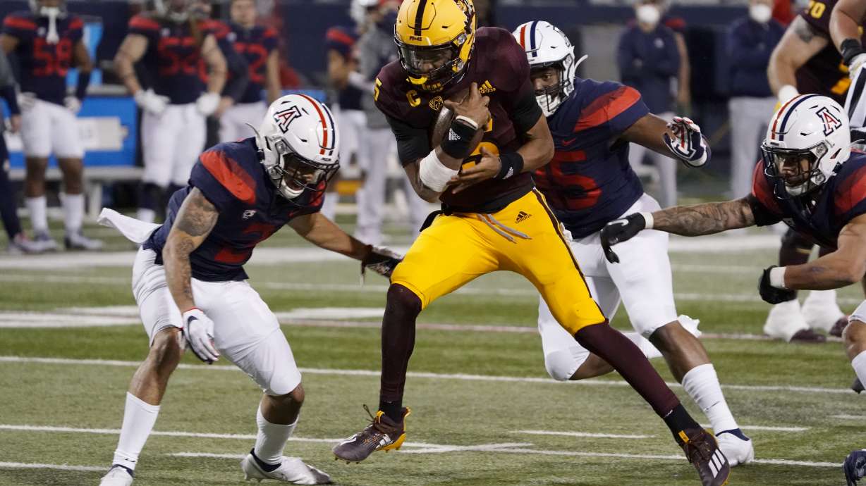 Arizona State quarterback Jayden Daniels (5) scores a touchdown against Arizona in the first half of an NCAA college football game, Friday, Dec. 11, 2020, in Tucson, Ariz.