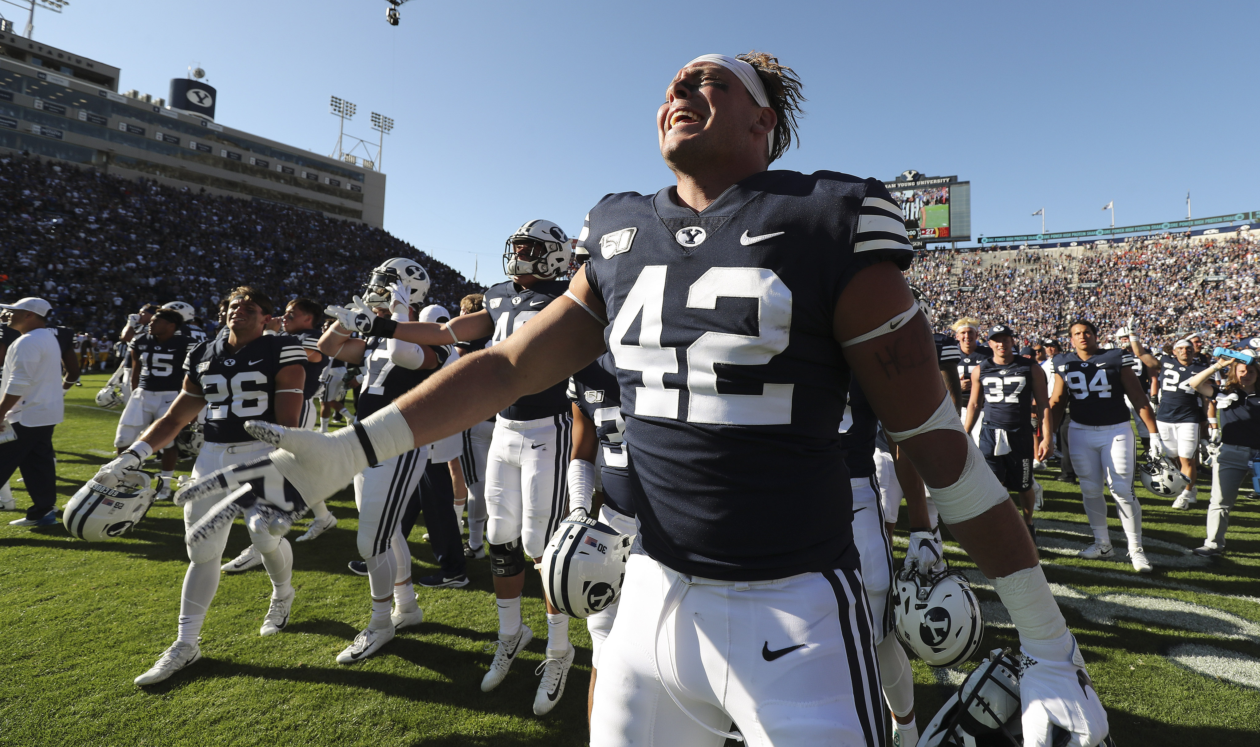 BYU tight end Kyle Griffitts (42) and BYU celebrate their win over the USC Trojans in Provo on Saturday, Sept. 14, 2019.