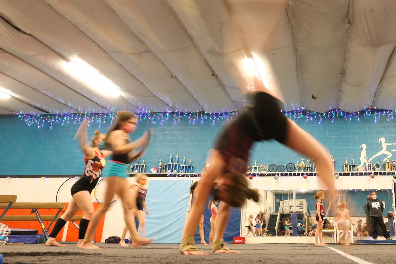 Students practice gymnastics skills during a class at
Hunt’s Gymnastic Academy in Midvale on Friday, Dec. 11, 2020. Due
to lost revenue from the coronavirus pandemic, the gym will close
at the end of the month.