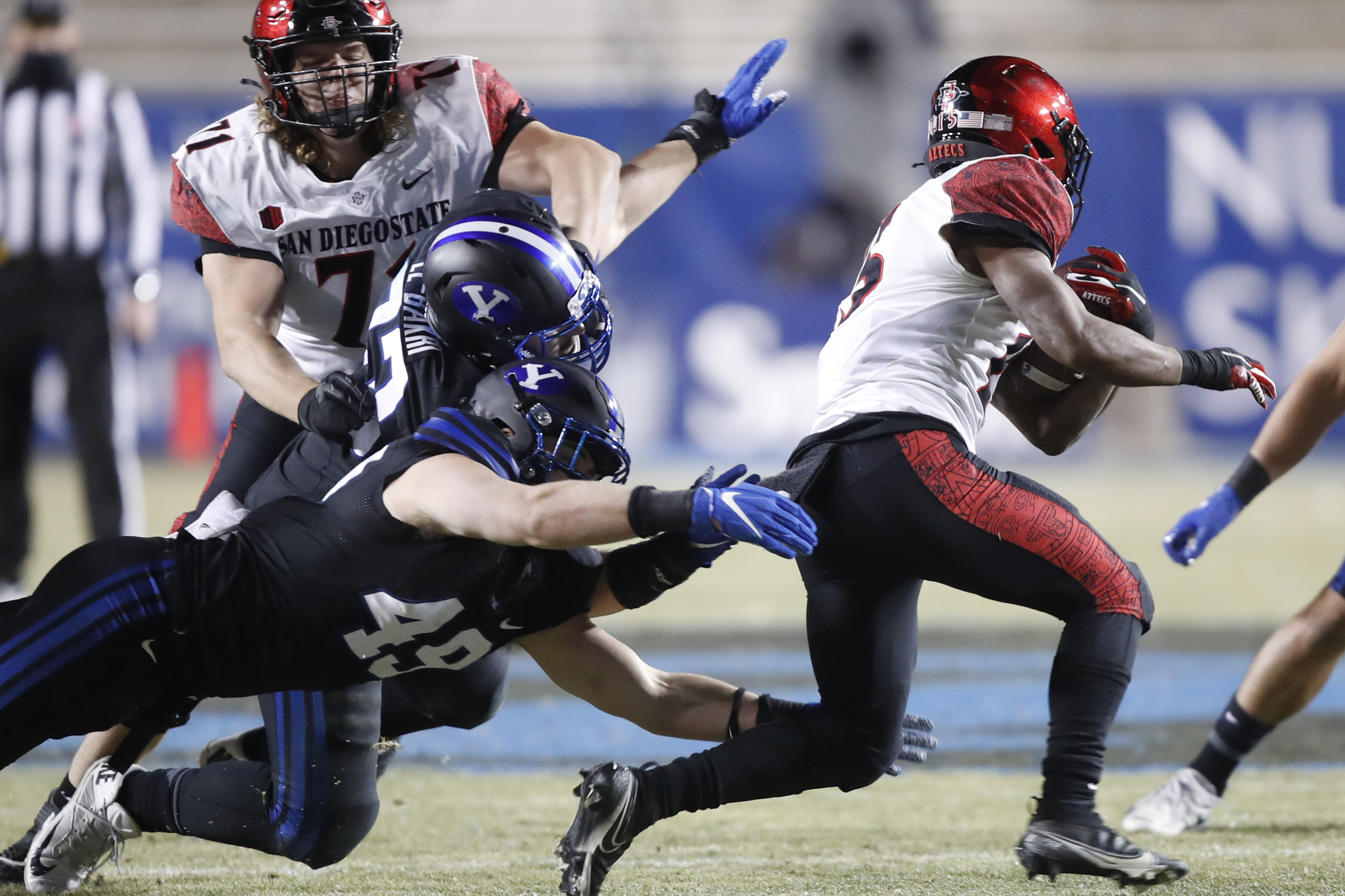 San Diego State running back Jordan Byrd (15) runs out of the tackle of BYU linebacker Payton Wilgar (49) in the first half of an NCAA college football game against Saturday, Dec. 12, 2020, in Provo, Utah. (AP Photo/George Frey, Pool)