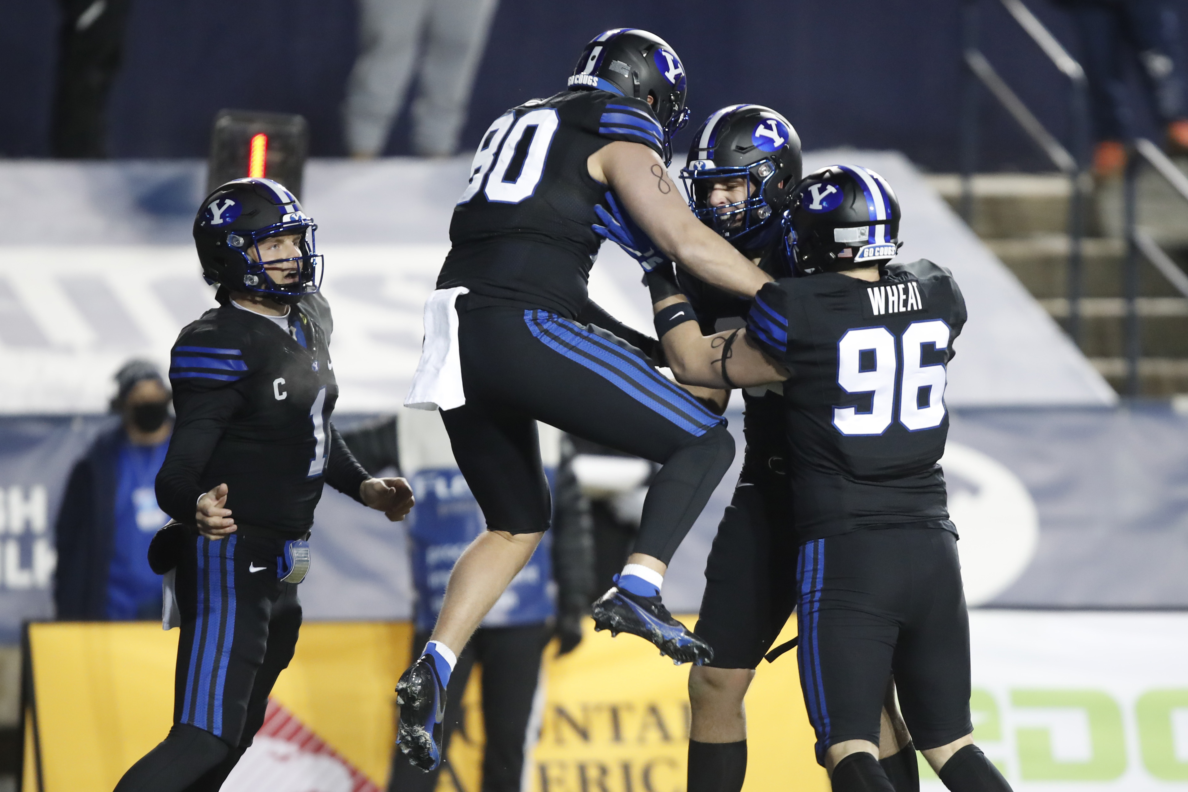 BYU quarterback Zach Wilson (1), tight end Lane Lunt (80) , BYU tight end Carter Wheat (96) and a teammate celebrate a touchdown in the first half of an NCAA college football game against San Diego State Saturday, Dec. 12, 2020, in Provo, Utah. (AP Photo/George Frey, Pool)