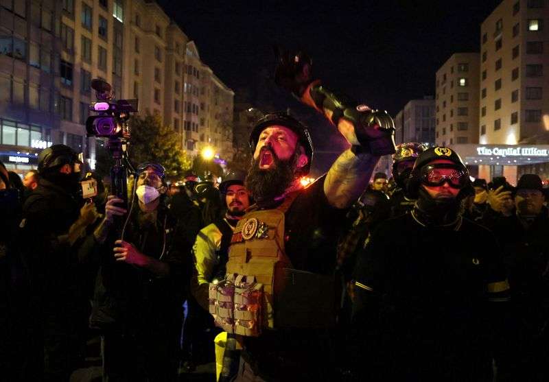 A member of the far-right group Proud Boys yells at police to let them through as they march on a street near the White House, during a rally to protest the results of the election, in Washington, U.S., December 12, 2020.