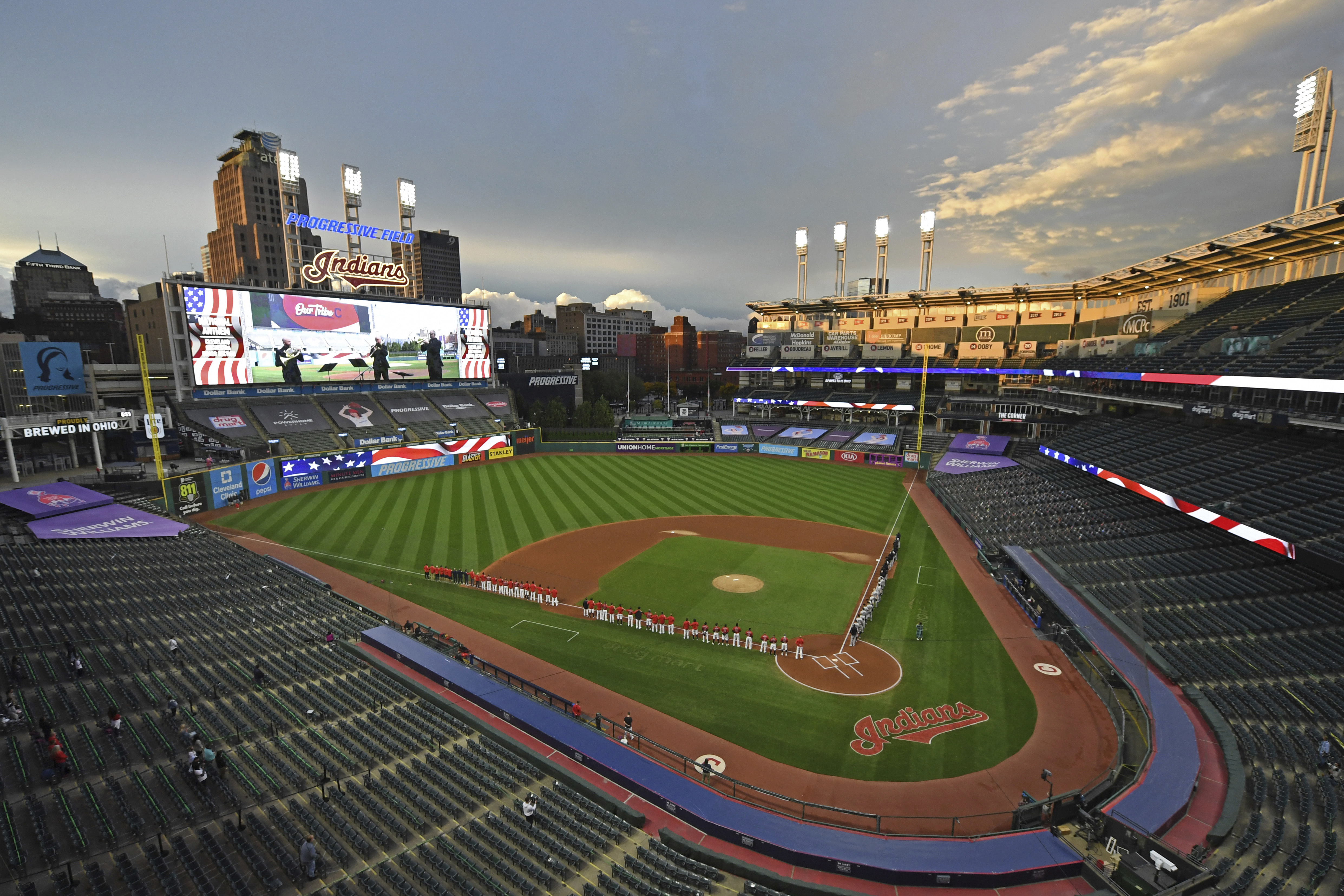 FILE - In this Sept. 29, 2020, file photo, players and coaches for the New York Yankees and the Cleveland Indians stand for the national anthem before Game 1 of an American League wild-card baseball series in Cleveland. The Indians are changing their name after 105 years, a person familiar with the decision told The Associated Press on Sunday, Dec. 13, 2020.