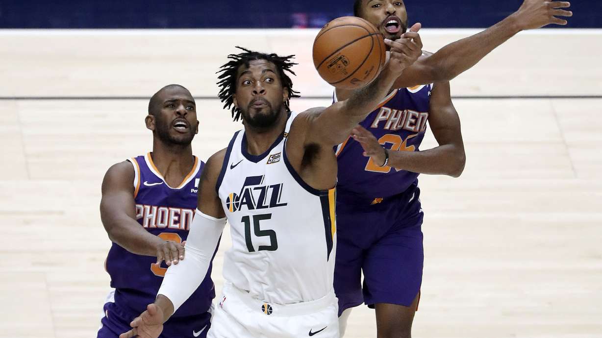 Utah Jazz center Derrick Favors (15) reaches for the ball in front of Phoenix Suns guard Chris Paul (3) and Phoenix Suns forward Mikal Bridges (25) during a preseason NBA game at the Vivint Smart Home Arena in Salt Lake City on Monday, Dec. 14, 2020.