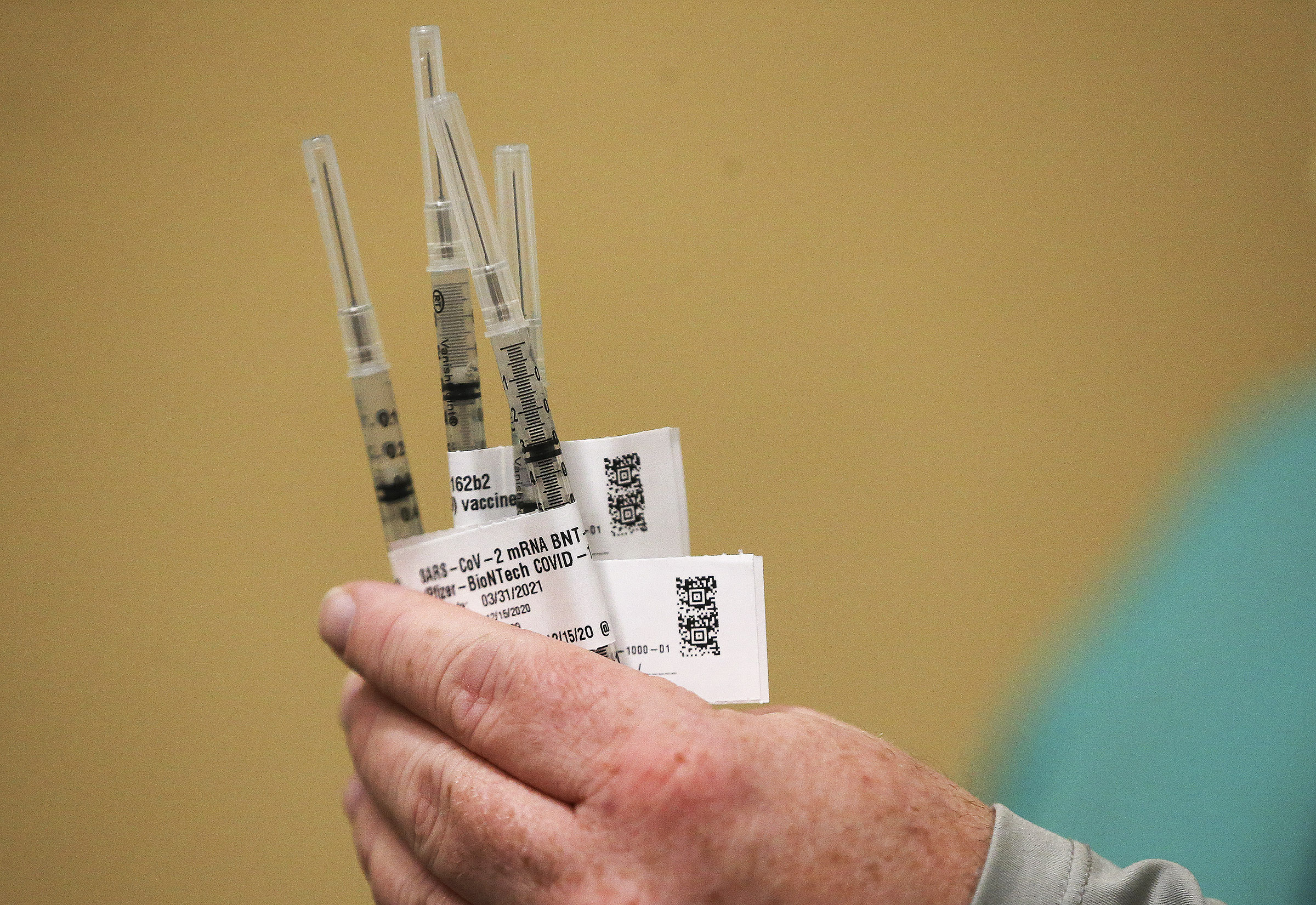 LDS Hospital pharmacy director Robb Dengg holds the first COVID-19 vaccines for hospital employees at the hospital in Salt Lake City on Tuesday, Dec. 15, 2020.