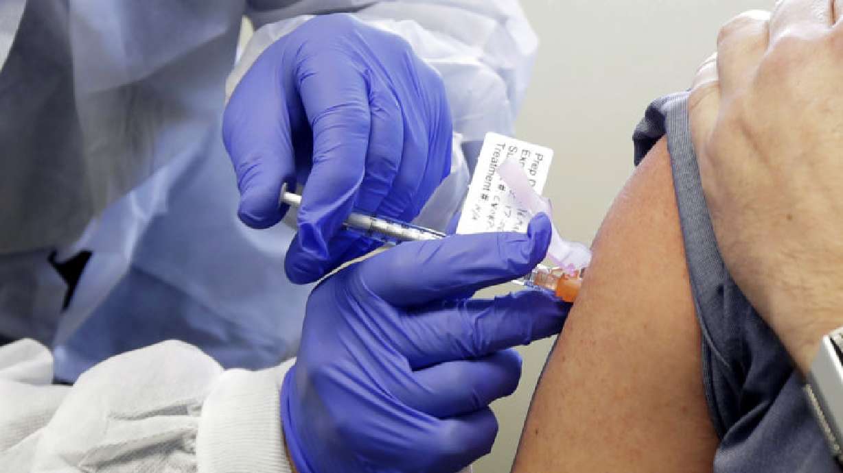 FILE - In this March 16, 2020, file photo, a subject receives a shot in the first-stage safety study clinical trial of a potential vaccine by Moderna for COVID-19, the disease caused by the new coronavirus, at the Kaiser Permanente Washington Health Research Institute in Seattle. According to results released on Tuesday, July 14, 2020, early-stage testing showed the first COVID-19 vaccine tested in the U.S. revved up peopleâs immune systems the way scientists had hoped. The vaccine is made by the National Institutes of Health and Moderna Inc. (AP Photo/Ted S. Warren, File)