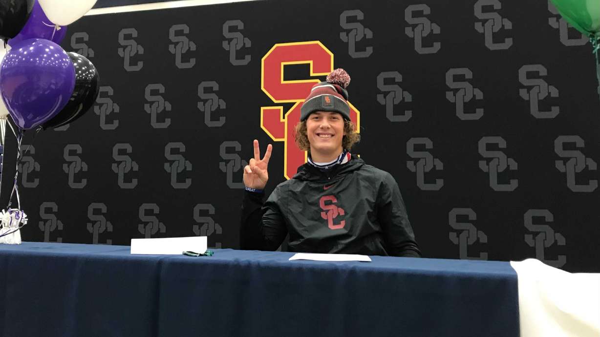 Jaxson Dart flashes 'Fight On' after signing with USC, Wednesday, Dec. 16, 2020 at Corner Canyon High School in Draper.