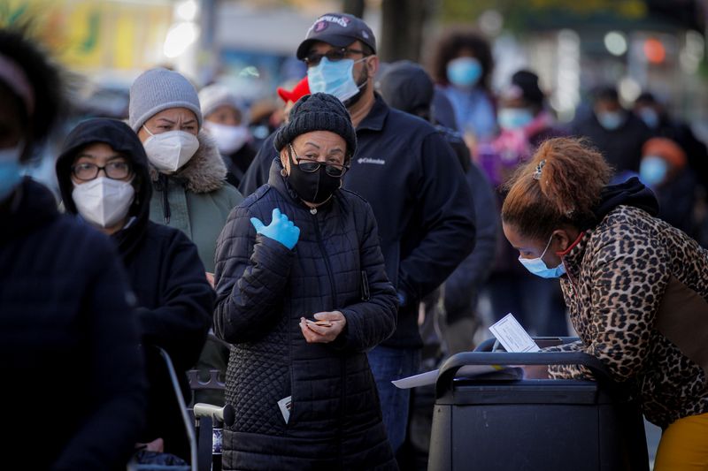 FILE PHOTO: People line up to receive free holiday boxes of food from the Food Bank For New York City ahead of the Thanksgiving holiday, as the global outbreak of the coronavirus disease (COVID-19) continues, in the Harlem neighborhood of New York, U.S., November 16, 2020.  REUTERS/Brendan McDermid