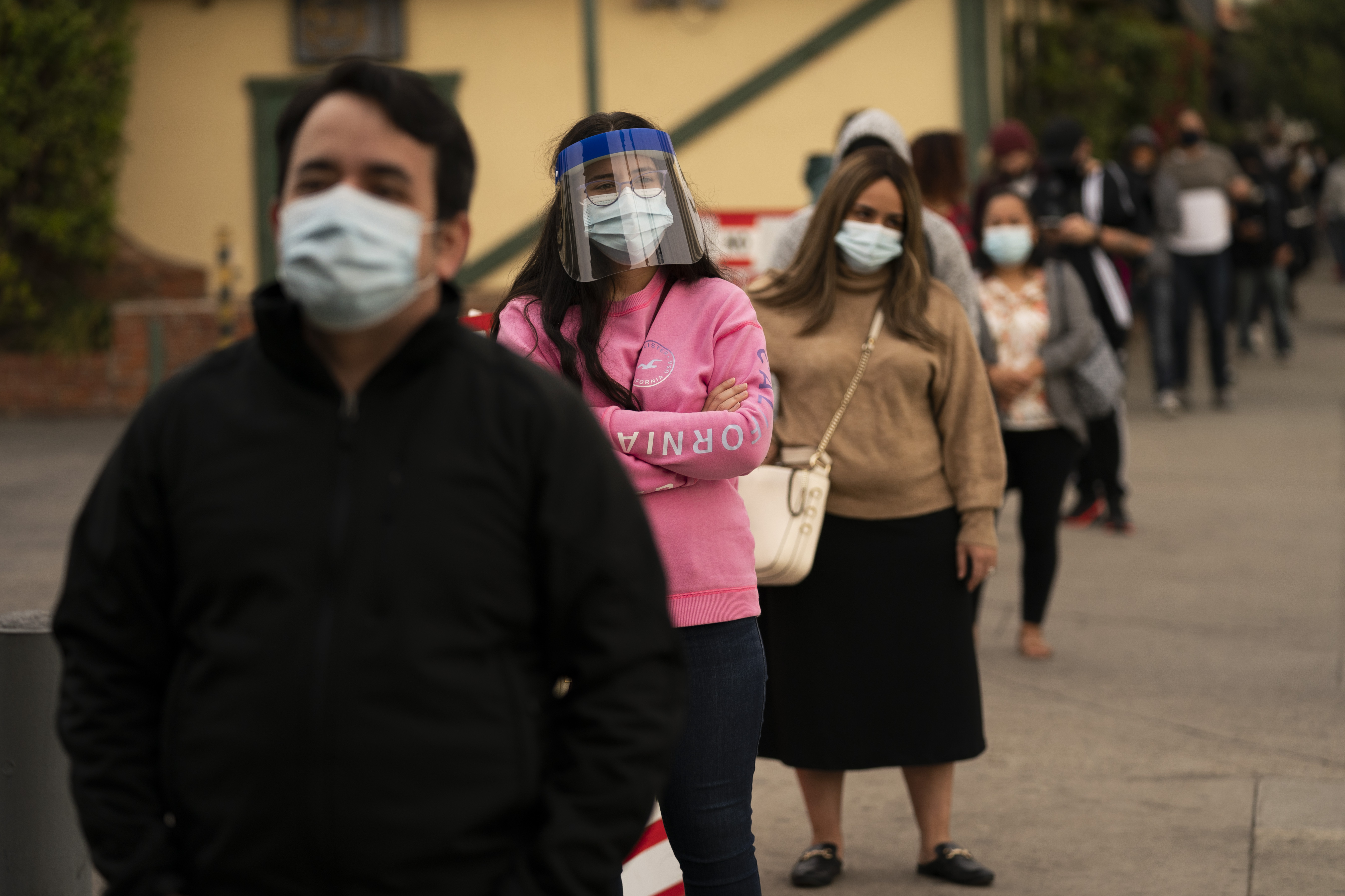 People wait in line for COVID-19 testing at a testing site operated by CORE in Los Angeles. The U.S. death toll from COVID-19 topped 600,000 on Tuesday, even as the vaccination drive has drastically brought down daily cases and fatalities.