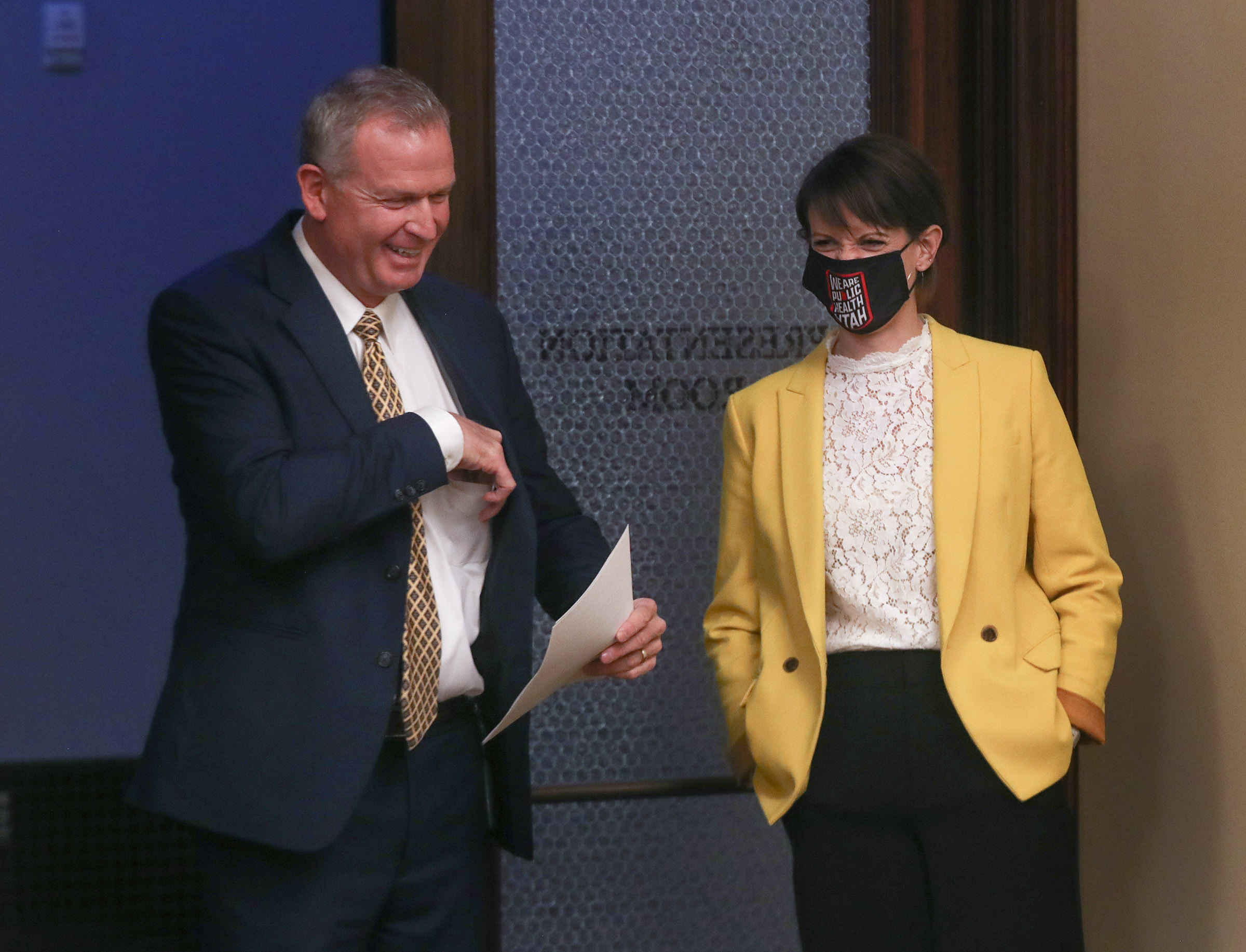 Rich Saunders, interim executive director for the Utah Department of Health, left, and state epidemiologist Dr. Angela Dunn share a laugh following a COVID-19 briefing at the Capitol in Salt Lake City on Thursday, Dec. 17, 2020.