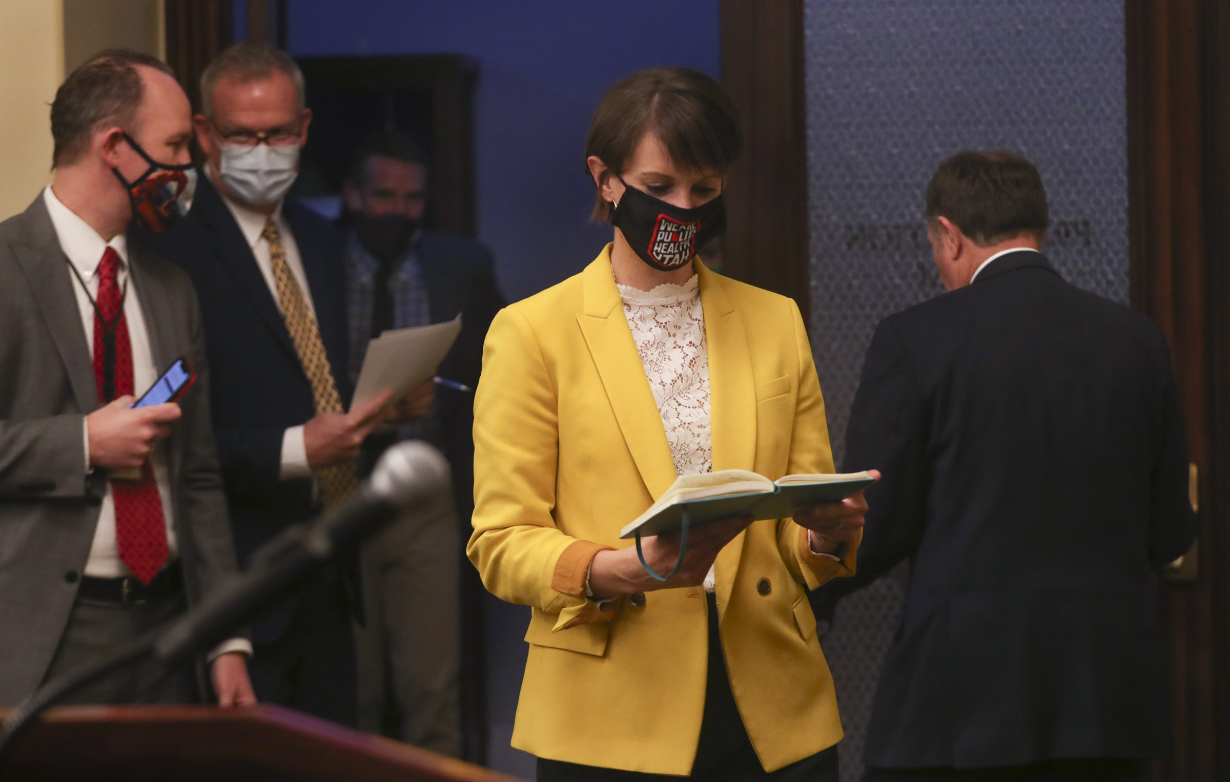 State epidemiologist Dr. Angela Dunnchecks her notes before talking about the pandemic and the number of positive COVID-19 cases in Utah during a briefing at the Capitol in Salt Lake City on Thursday, Dec. 17, 2020.