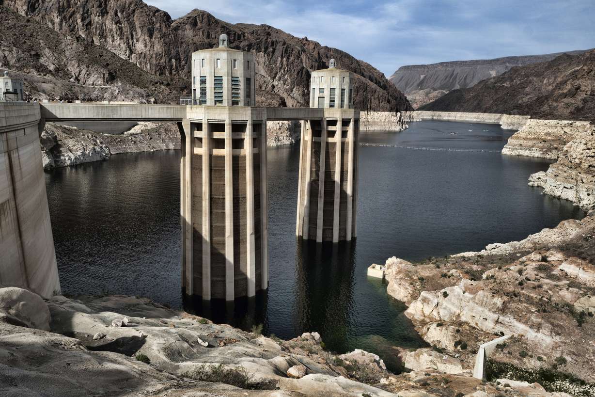 FILE - This March 26, 2019, file photo, shows a bathtub ring of light minerals showing the high water mark of the reservoir which has shrunk to its lowest point on the Colorado River, as seen from the Hoover Dam, Ariz. A set of guidelines for managing the Colorado River helped several states through a dry spell, but it's not enough to keep key reservoirs in the American West from plummeting amid persistent drought and climate change, according to a U.S. report released Friday, Dec. 18, 2020.