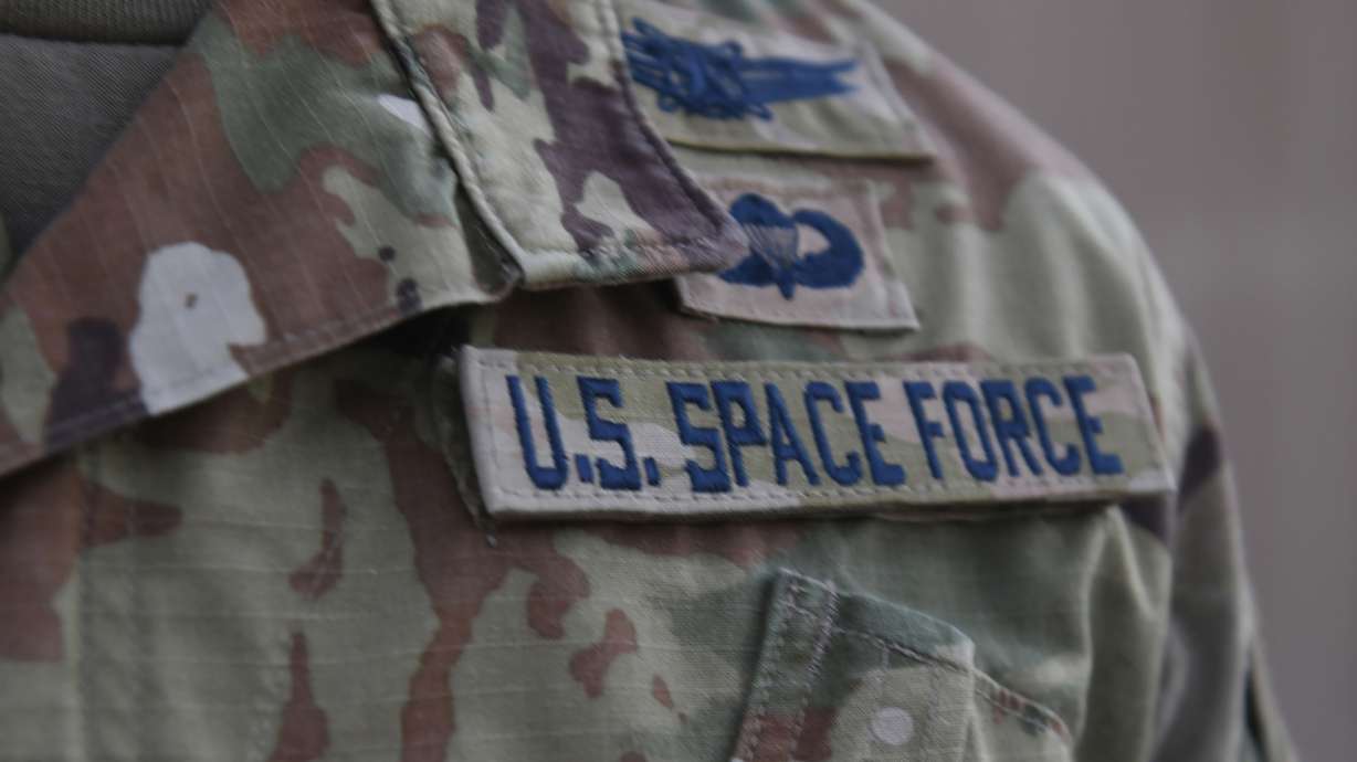 In this photo released by the U.S. Air Force, Capt. Ryan Vickers stands for a photo to display his new service tapes after taking his oath of office to transfer from the U.S. Air Force to the U.S. Space Force at Al-Udeid Air Base, Qatar, Tuesday, Sept. 1, 2020. Space Force, the first new U.S. military service since the creation of the Air Force in 1947, now has some 20 members stationed at Qatar's Al-Udeid Air Base in its first foreign deployment. (Staff Sgt. Kayla White/U.S. Air Force via AP)