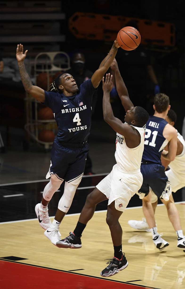 BYU guard Brandon Averette (4) blocks a shot by San Diego State guard Terrell Gomez (3) during the second half of an NCAA college basketball game Friday, Dec. 18, 2020, in San Diego.