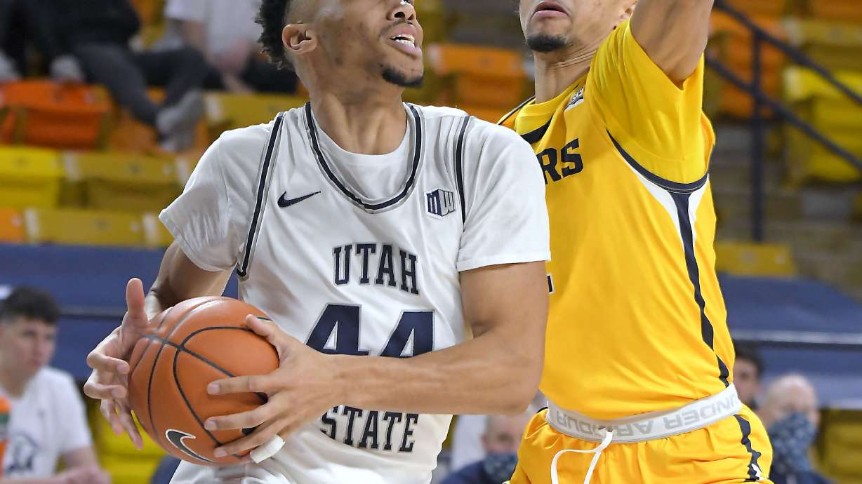 Utah State guard Marco Anthony (44) drives to the basket as Northern Colorado guard Daylen Kountz defends during the second half of an NCAA college basketball game Friday, Dec. 18, 2020, in Logan, Utah.