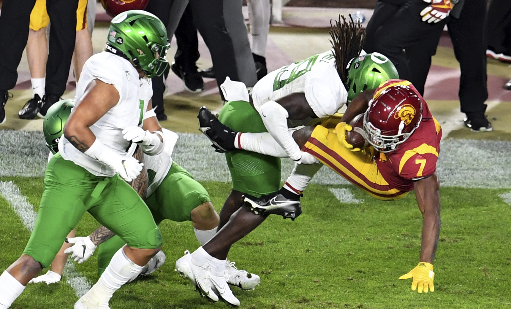 USC Running back Stephen Carr, right, runs for a first down and is tackled by Oregon safety Jamal Hill first half of an NCAA college football game at the Los Angeles Memorial Coliseum in Los Angeles on Friday, Dec. 18, 2020.