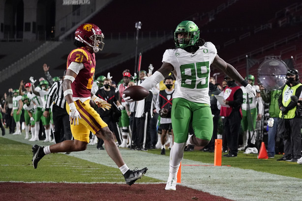 Oregon tight end DJ Johnson (89) runs to the end zone for a touchdown against Southern California safety Isaiah Pola-Mao (21) during the first quarter of an NCAA college football game for the Pac-12 Conference championship Friday, Dec 18, 2020, in Los Angeles.