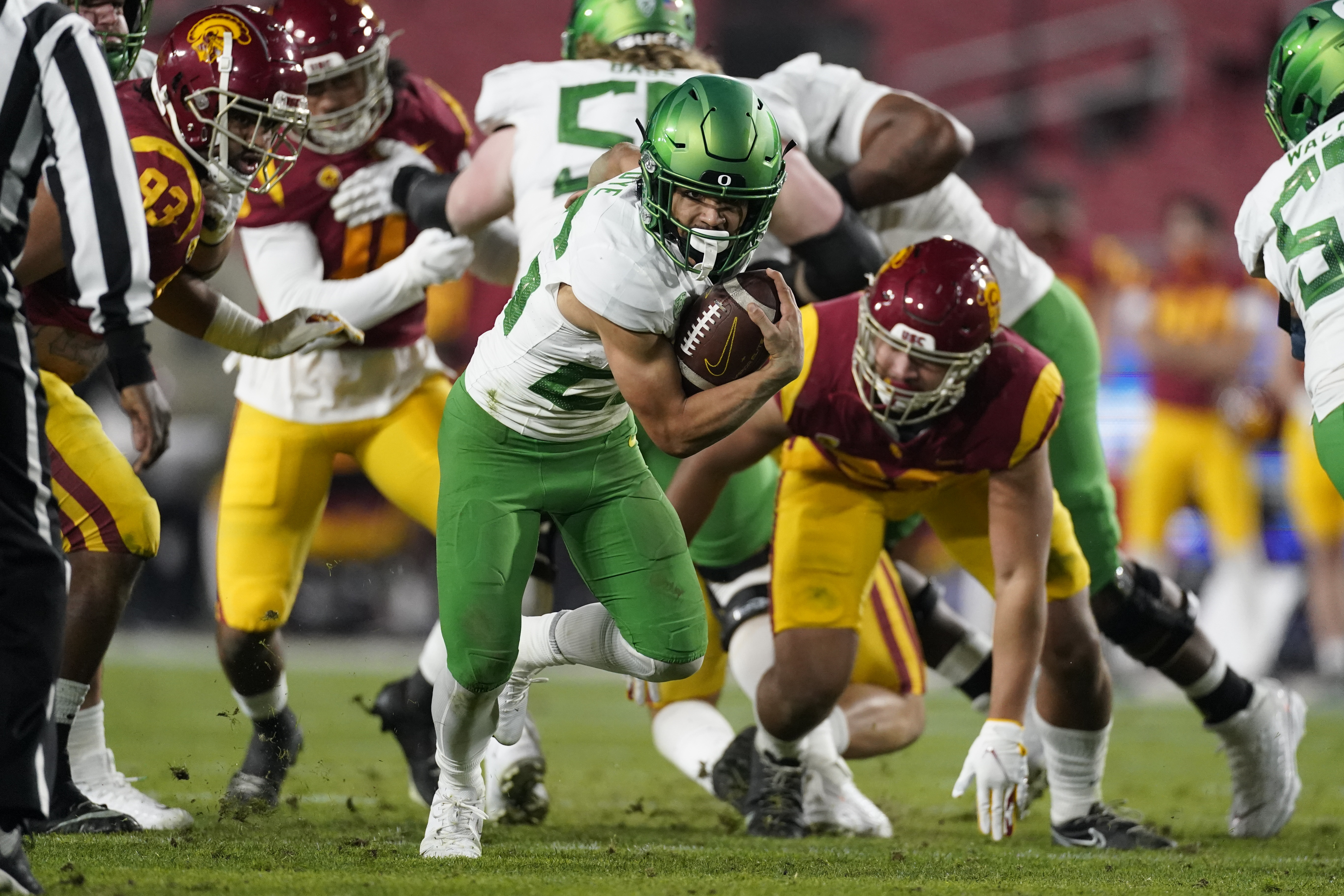 Oregon running back Travis Dye (26) runs the ball during the first quarter of an NCAA college football game for the Pac-12 Conference championship against Southern California Friday, Dec 18, 2020, in Los Angeles.