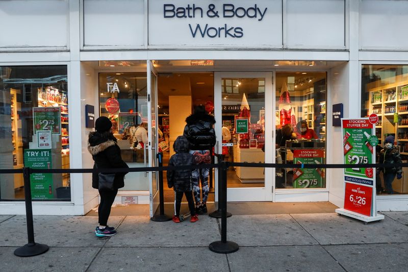 Shoppers wait in line outside a Bath and Body Works retail store in Brooklyn, N.Y., in December 2020.  The company apologized for selling candles that looked like Ku Klux Klan hoods.