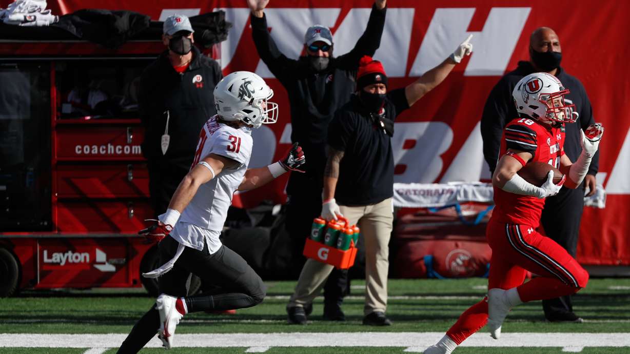 Utah Utes wide receiver Britain Covey (18) carries the ball and runs into the end zone for a touchdown during an NCAA football game at Rice-Eccles Stadium in Salt Lake City on Saturday, Dec. 19, 2020.