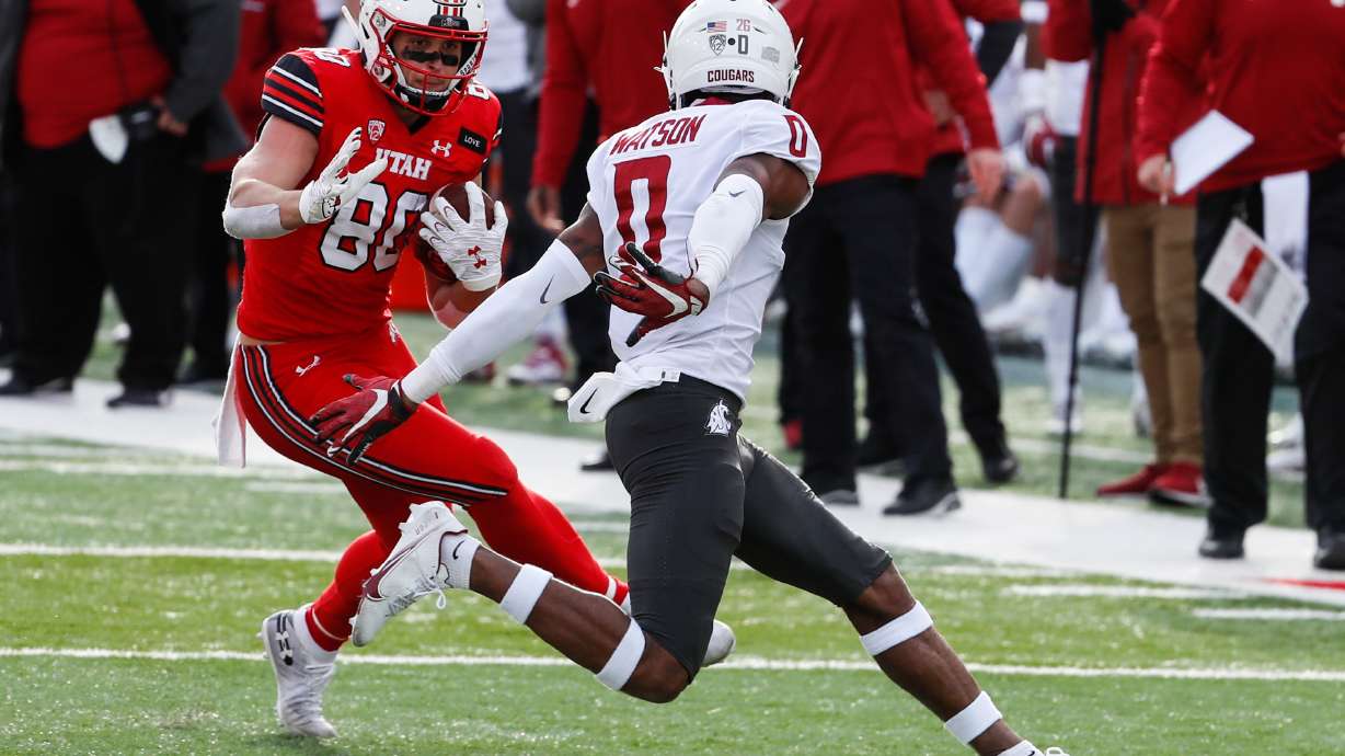 Utah Utes tight end Brant Kuithe (80) carries the ball against Washington State Cougars defensive back Jaylen Watson (0) during an NCAA football game at Rice-Eccles Stadium in Salt Lake City on Saturday, Dec. 19, 2020.