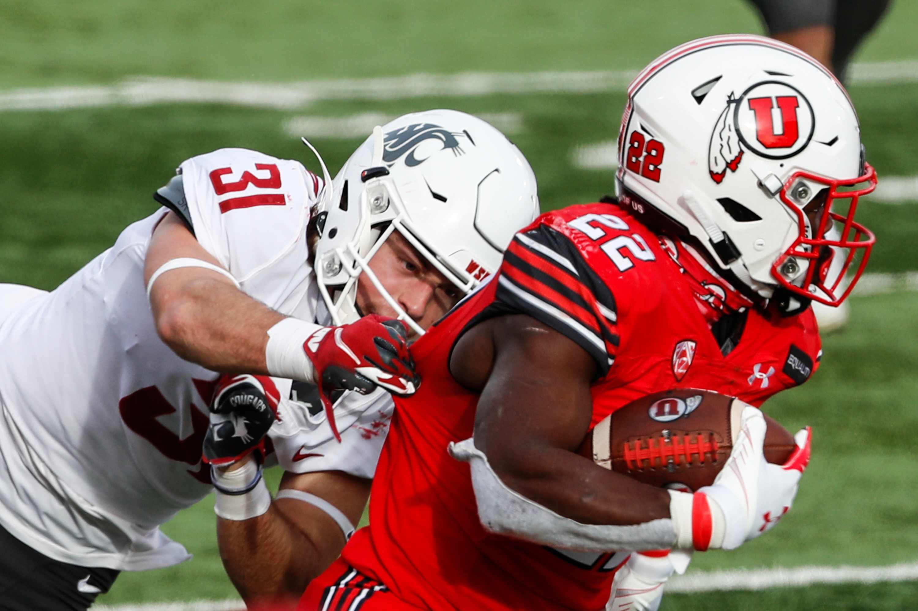 Utah Utes running back Ty Jordan (22) carries the ball against Washington State Cougars defensive back Hunter Escorcia (31) during an NCAA football game at Rice-Eccles Stadium in Salt Lake City on Saturday, Dec. 19, 2020.