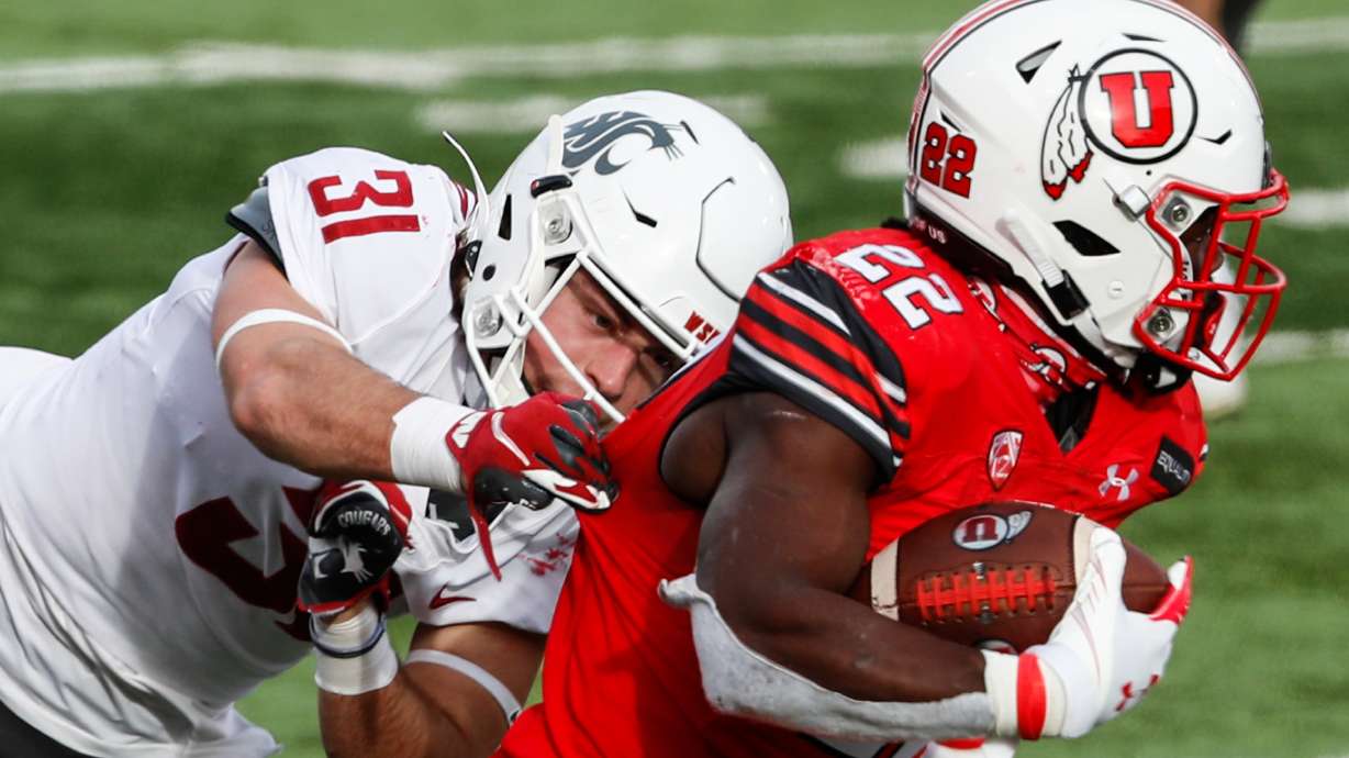 Utah Utes running back Ty Jordan (22) carries the ball against Washington State Cougars defensive back Hunter Escorcia (31) during an NCAA football game at Rice-Eccles Stadium in Salt Lake City on Saturday, Dec. 19, 2020.