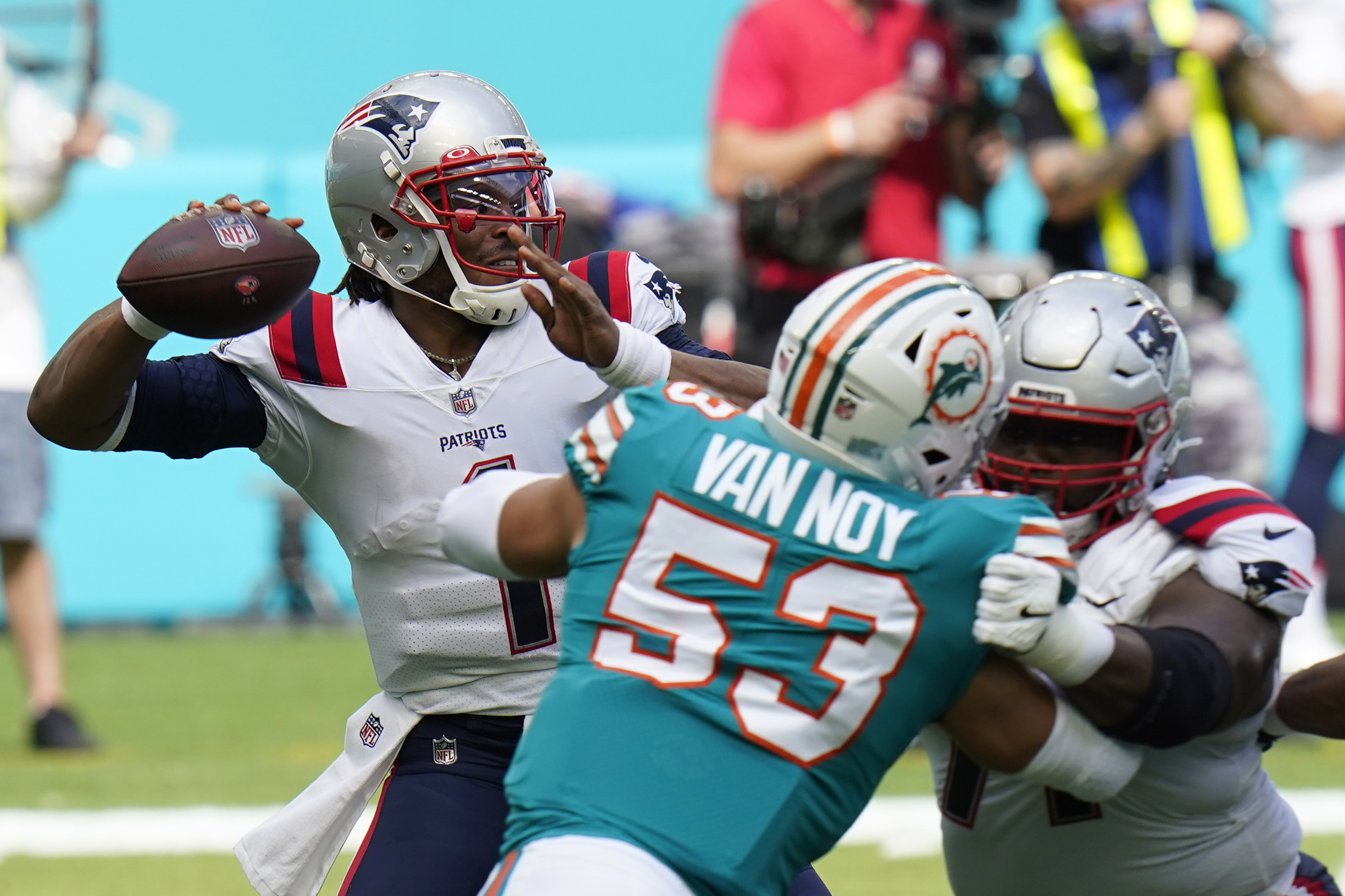 New England Patriots quarterback Cam Newton (1) looks to pass the football during the first half of an NFL football game against the Miami Dolphins, Sunday, Dec. 20, 2020, in Miami Gardens, Fla.
