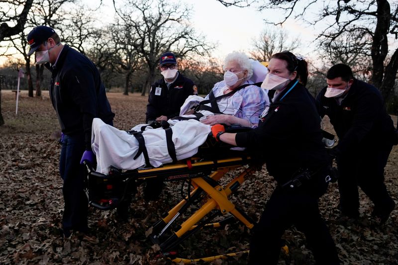 REACT EMS paramedics prepare to transport an 87-yearold woman who had been exposed to the coronavirus disease (COVID-19) and was experiencing symptoms in Meeker, Oklahoma, U.S. December 20, 2020. REUTERS/Nick Oxford