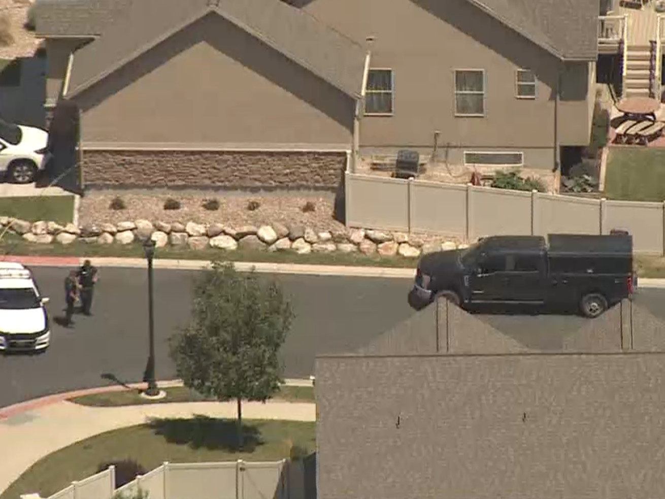 Police are seen Friday, July 24, 2020, at the scene
where explosives were found in a South Jordan home following an
hourslong standoff that started the night before.