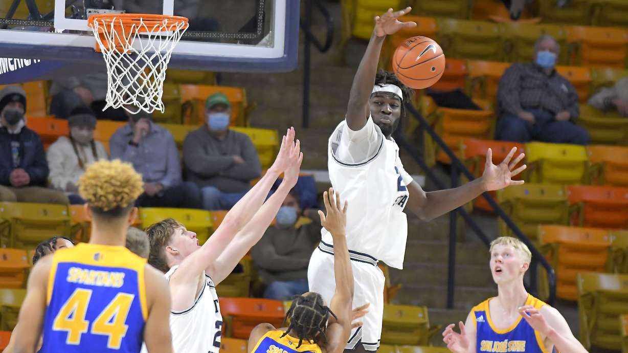 Utah State center Neemias Queta blocks the shot of San Jose State guard Caleb Simmons during the first half of an NCAA college basketball game Monday, Dec. 21, 2020, in Logan, Utah. (Eli Lucero/The Herald Journal via AP, Pool)