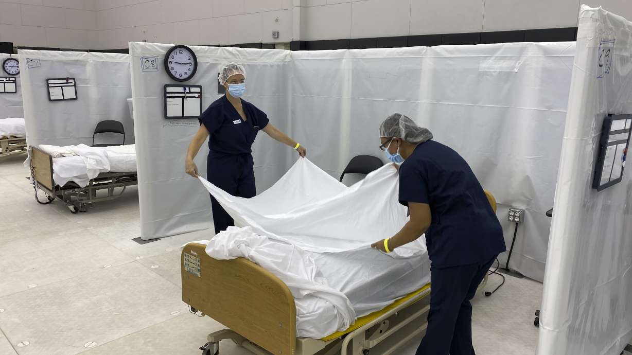FILE - This Wednesday, Dec. 9, 2020 photo provided by the California Office of Emergency Services (OES) shows hospital beds set up in the practice facility at Sleep Train Arena in Sacramento, Calif., that is ready to receive patients as needed. This is the deadliest year in U.S. history, with deaths topping 3 million for the first time. It's due mainly to the coronavirus pandemic that has killed nearly 320,000 Americans.