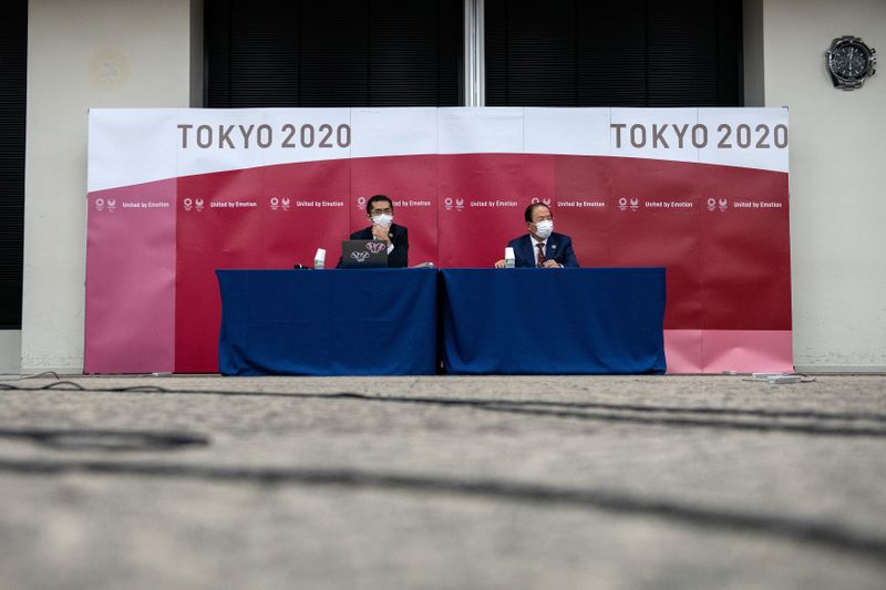 Tokyo 2020 Olympic Games CEO Toshiro Muto (R) speaks during a news conference following a Tokyo 2020 Olympics Executive Board meeting in Tokyo, Japan December 22, 2020. Carl Court/Pool via REUTERS