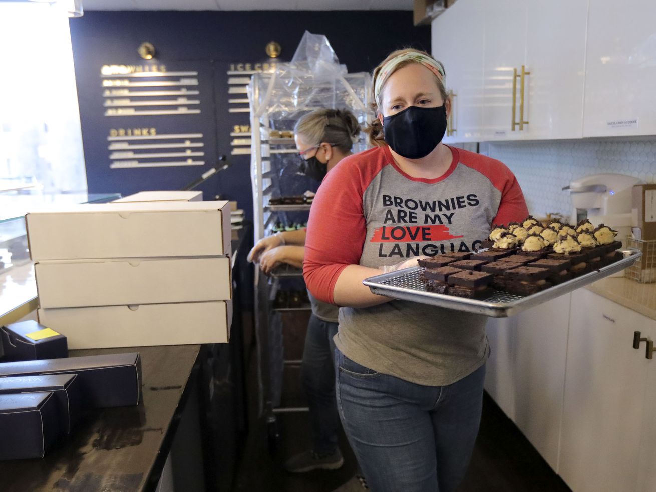Molly Kohrman, owner of Brownies! Brownies! Brownies!,
pulls out a tray of brownies that need toppings at Brownies!
Brownies! Brownies! in Salt Lake City on Tuesday, Dec. 22, 2020.